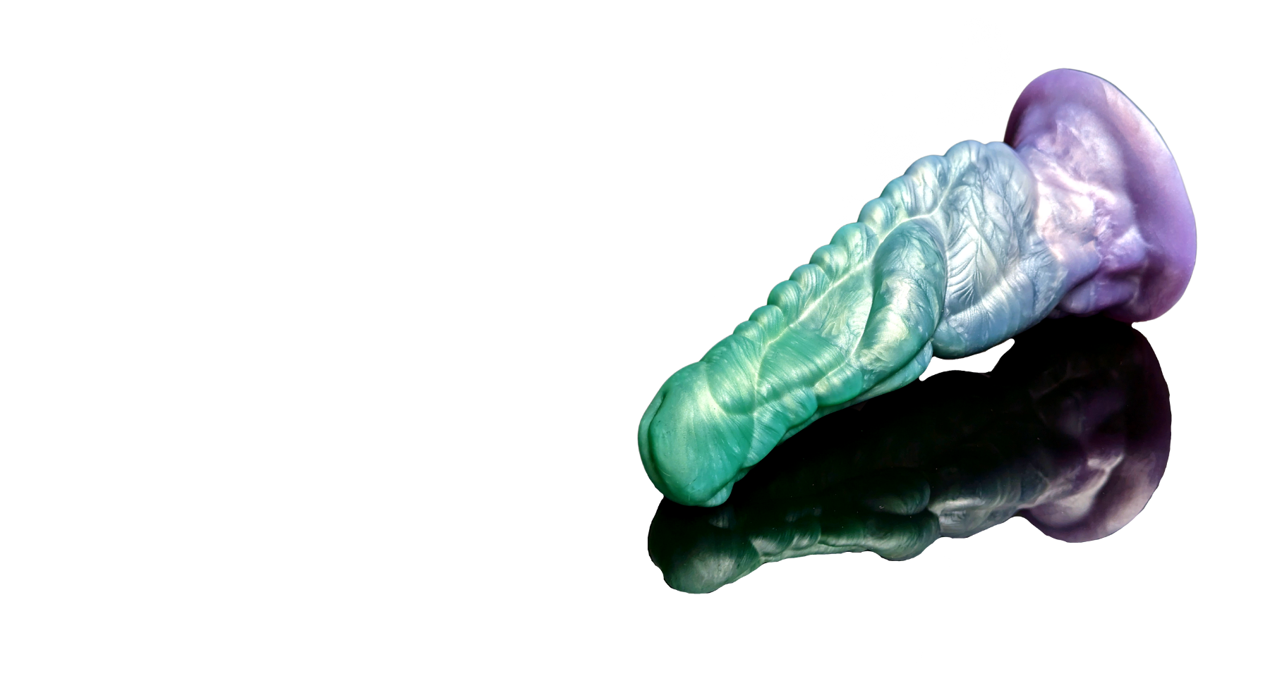 Fade color Xenu alien dildo on a reflective surface with a white wispy smoke background